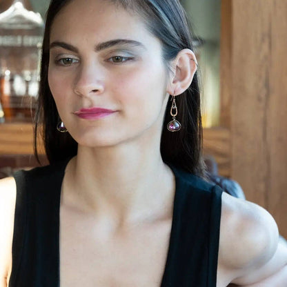 Woman wearing earrings with a blurred indoor background
