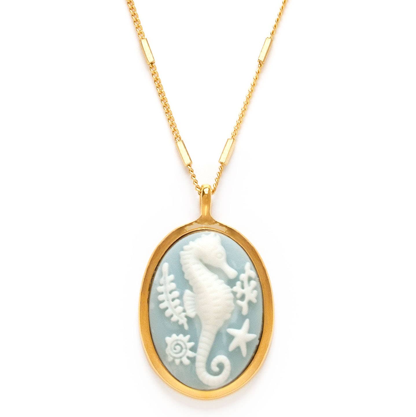 Gold necklace with a pendant featuring a white seahorse design on a white background.