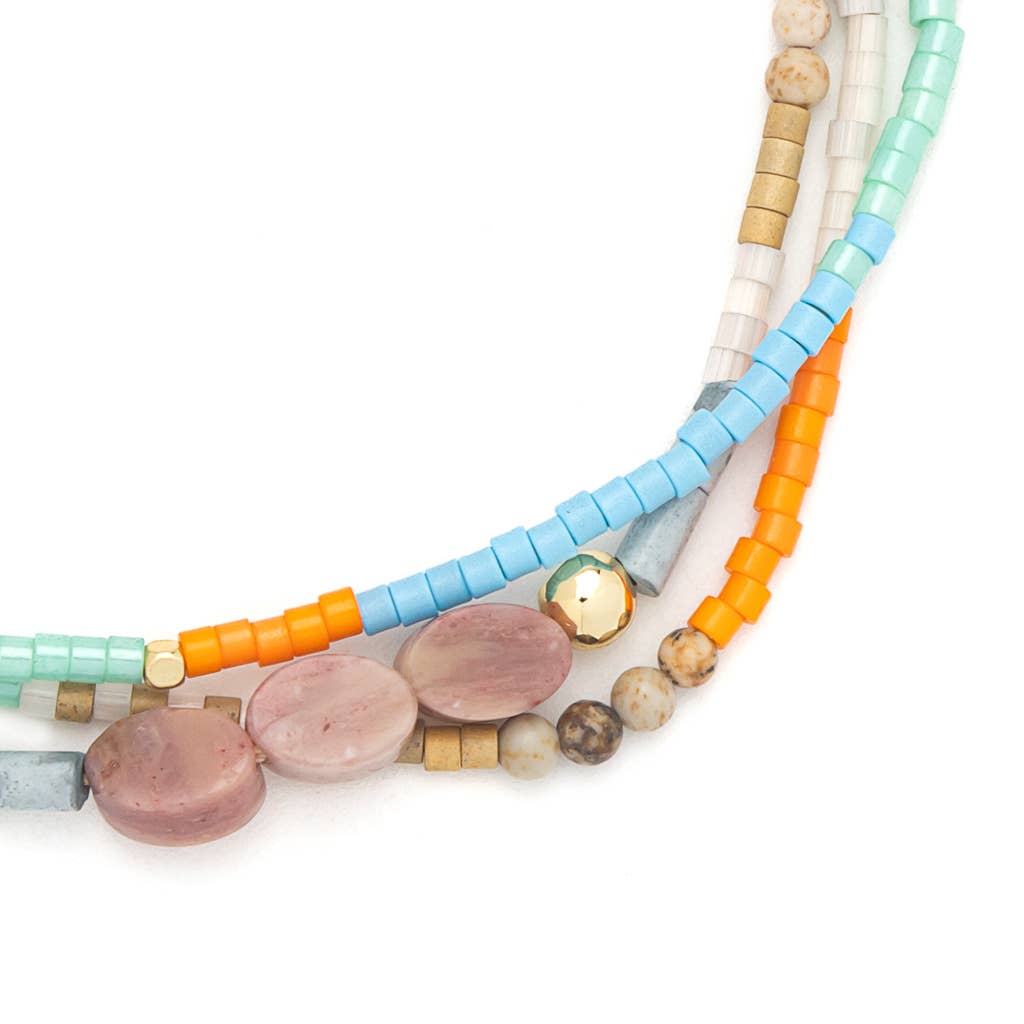 Colorful beaded bracelet with multiple strands on a white background