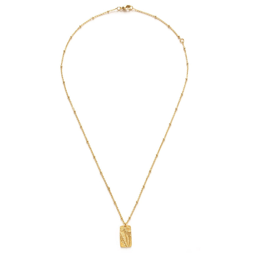 Gold necklace with a rectangular pendant on a white background