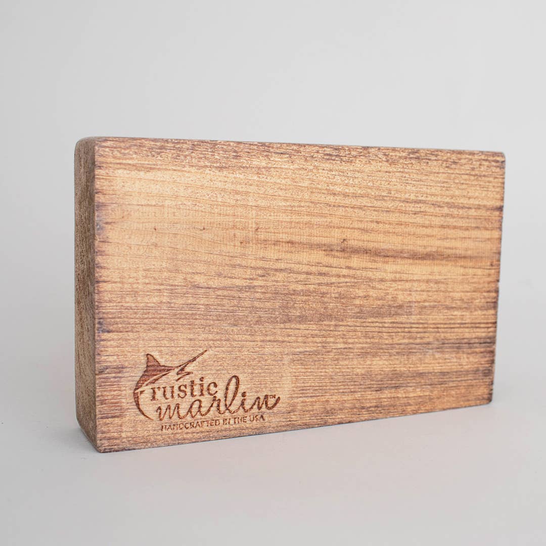 Wooden block with 'Rustic Marlin' branding on a gray background