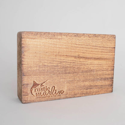 Wooden block with 'Rustic Marlin' branding on a gray background