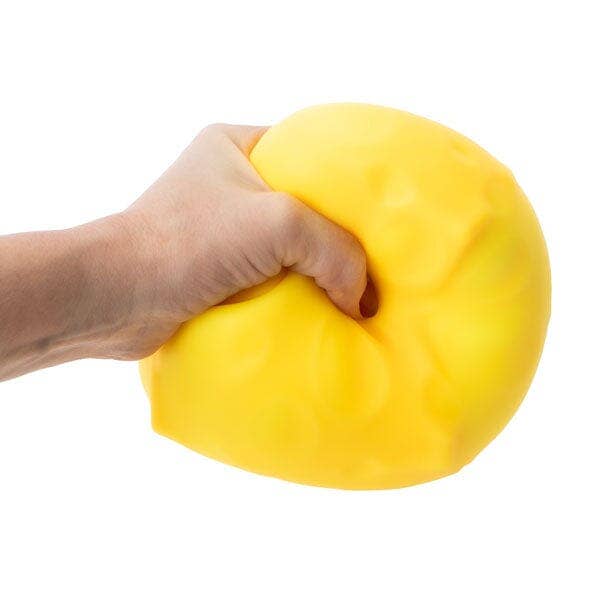 Hand holding a yellow cheese stress ball against a white background