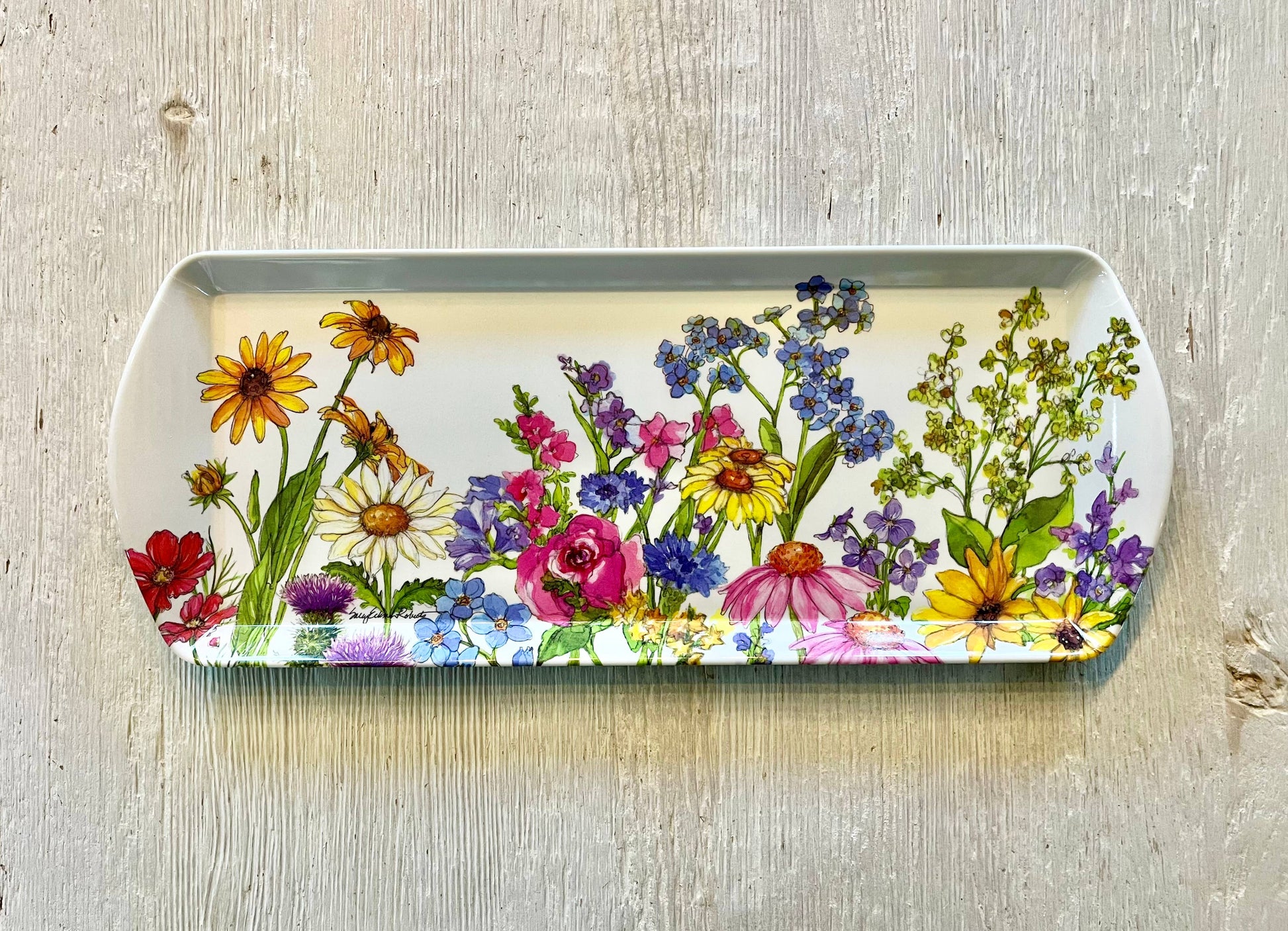 Rectangular tray with colorful floral design on a wooden surface