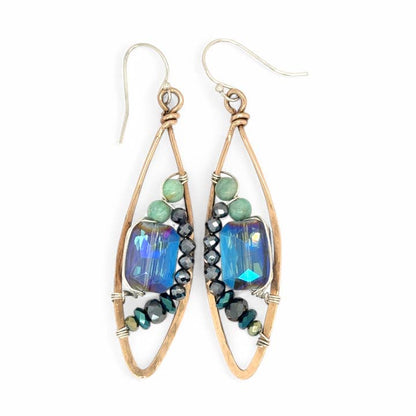 Pair of earrings with blue and green beads on a white background