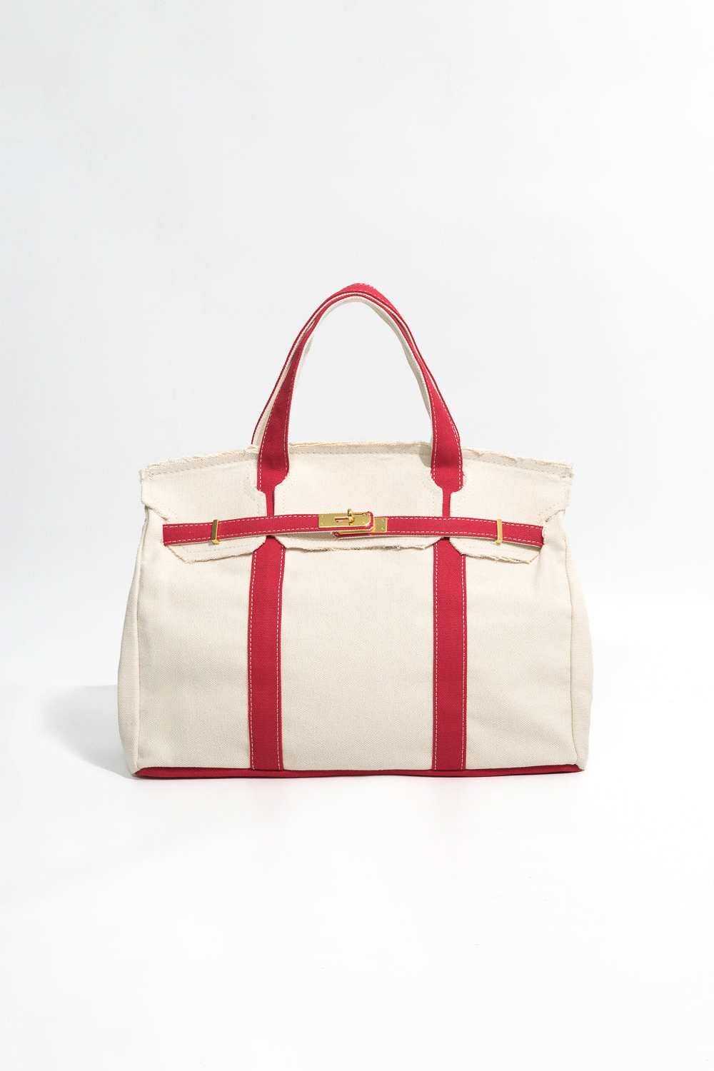 Beige tote bag with red straps and trim on a white background