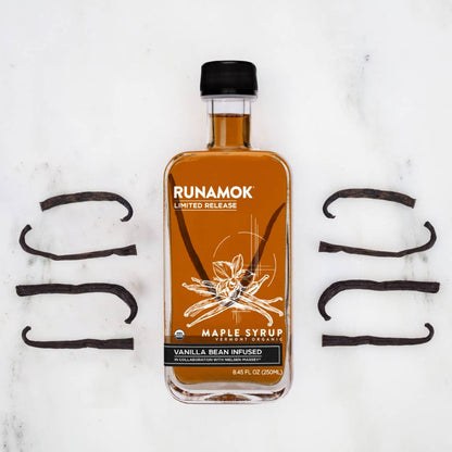 Bottle of Runamok maple syrup with vanilla bean on a white background