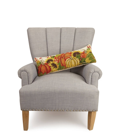 Gray armchair with a decorative pillow featuring pumpkins and sunflowers on a white background