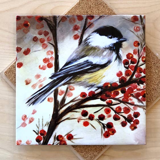 Trivet with a painted design of a bird on a branch with red berries.