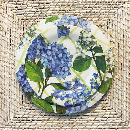 Decorative plates with blue floral design on a woven surface