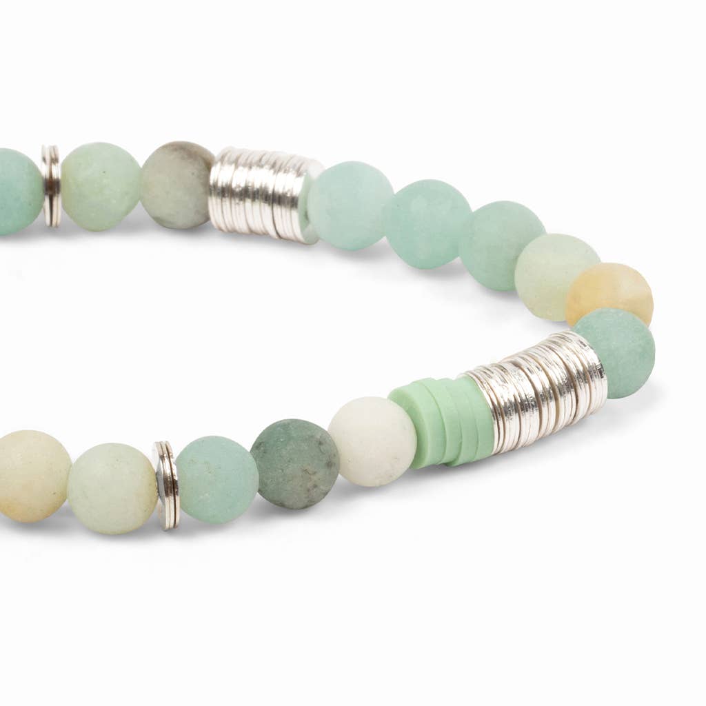 Bracelet with green beads and silver accents on a white background