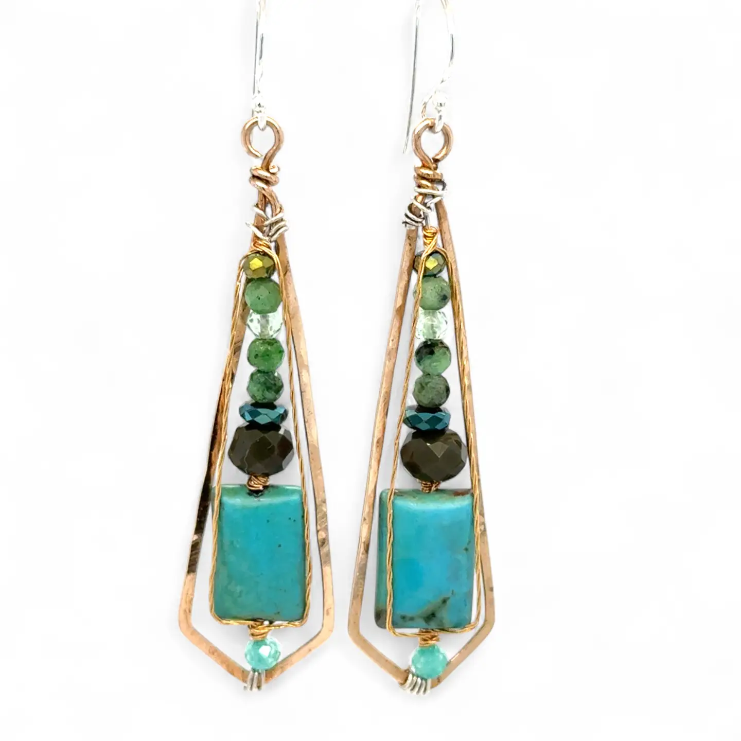 Gold-framed earrings with green and turquoise stones on a white background