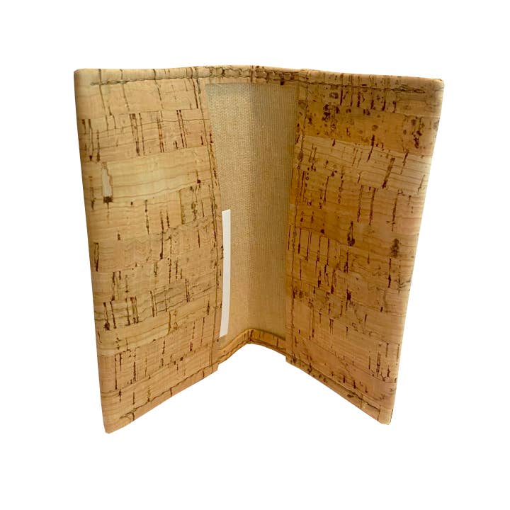 A cork wallet shown open, displaying its natural cork exterior with a textured grain pattern and a beige fabric interior lining.
