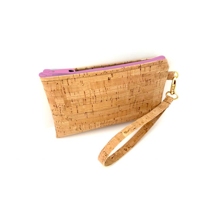 A wristlet purse made from cork fabric with a pink zipper and a wrist strap, handcrafted in the USA.