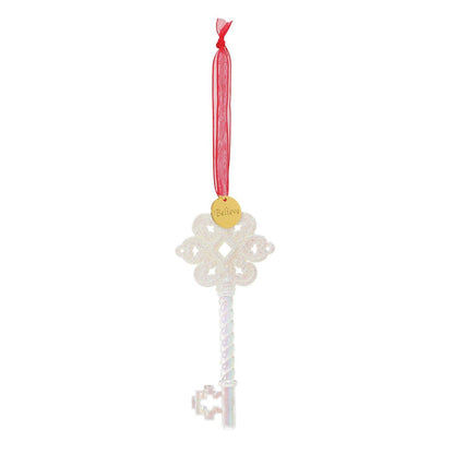 Decorative key ornament with a red ribbon on a white background
