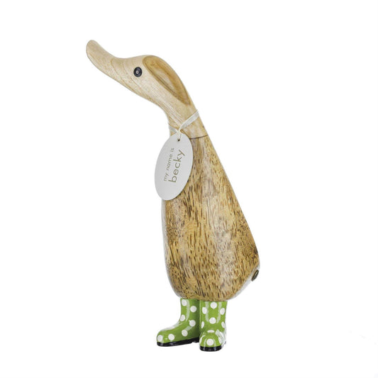 Wooden duck figurine with a tag and green polka dot boots on a white background