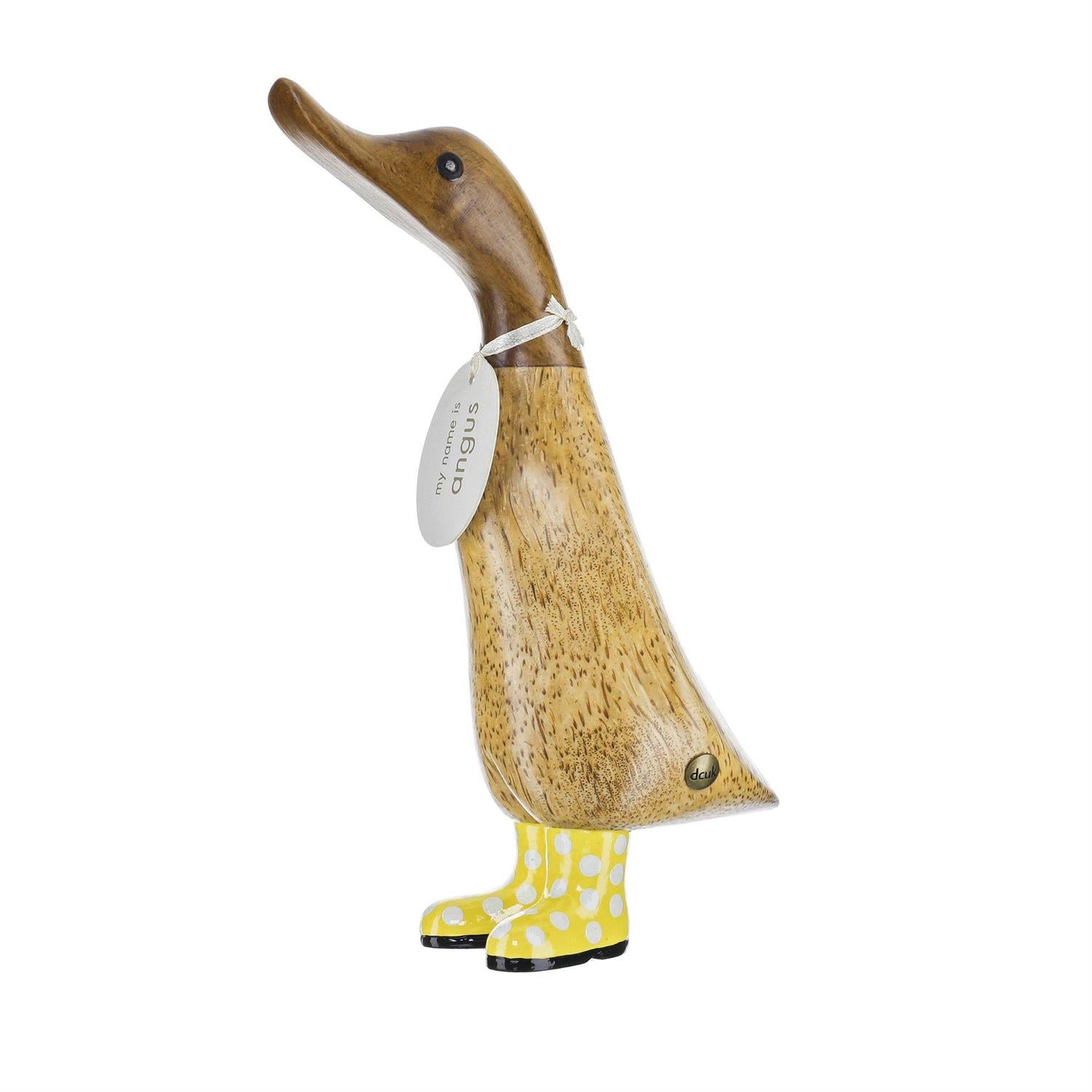 Wooden duck figurine wearing yellow boots on a white background