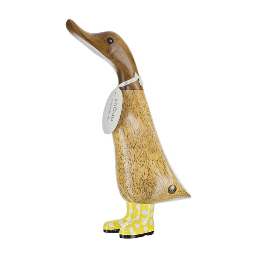 Wooden duck figurine wearing yellow boots on a white background