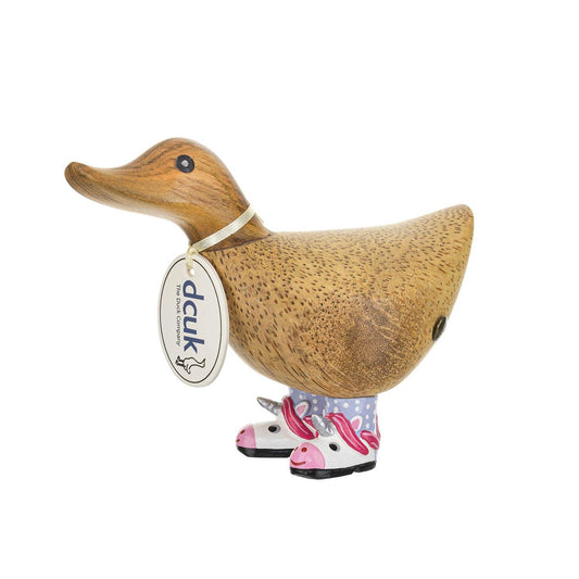 Wooden duck figurine with a tag and unicorn boots on a white background