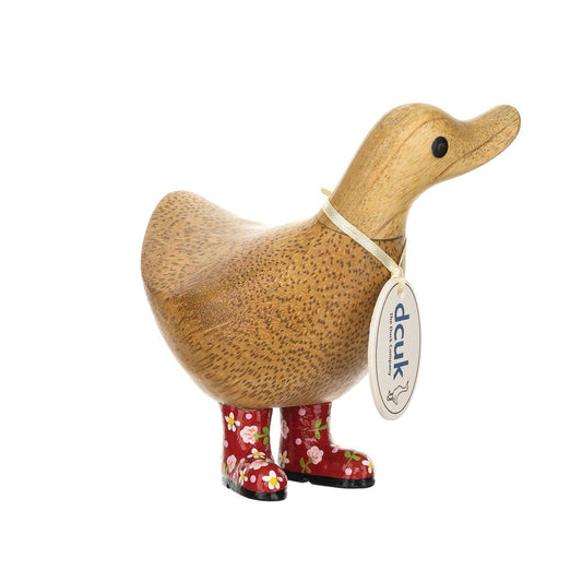 Wooden duck figure with floral-patterned boots and a tag on a white background