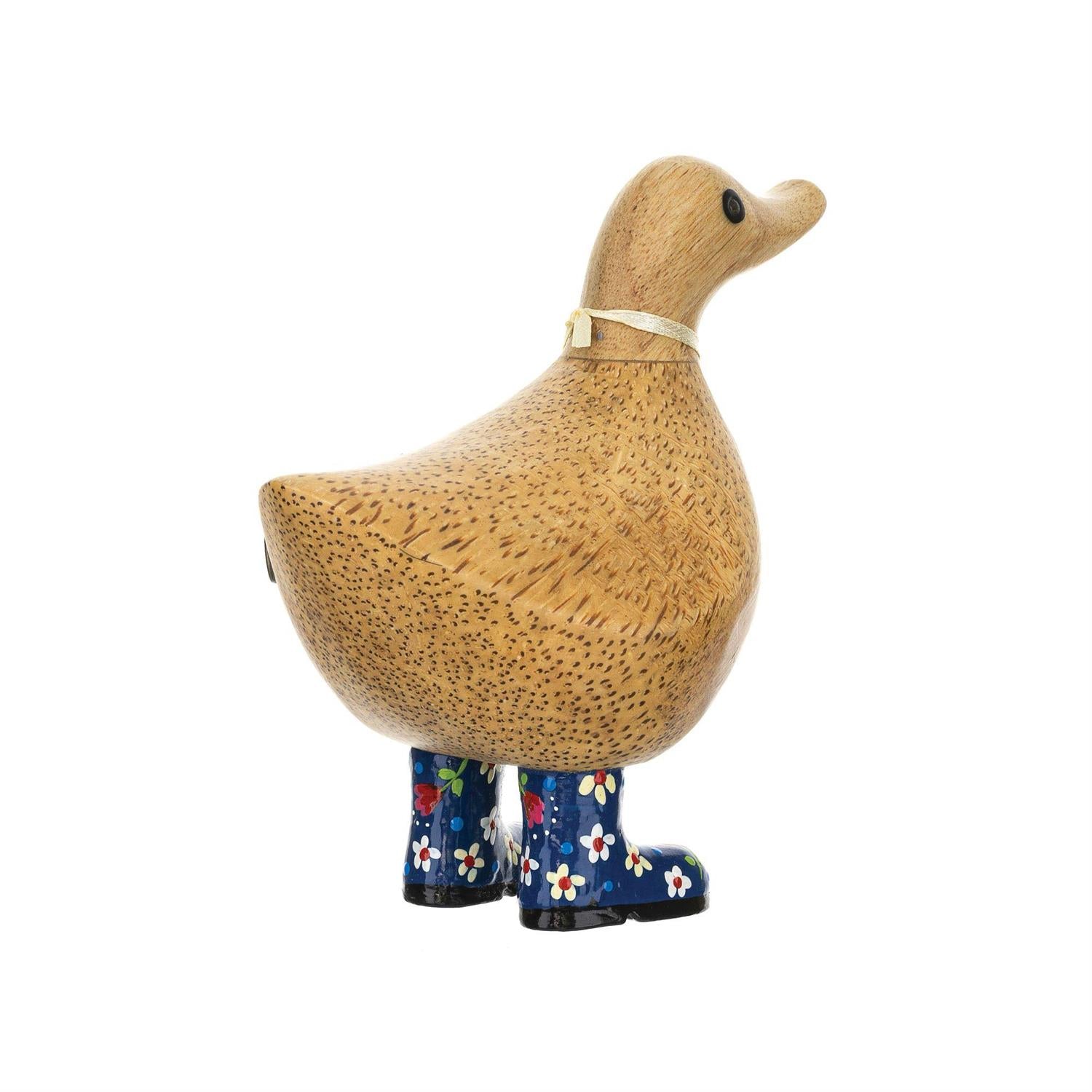 Wooden duck with floral-patterned boots on a white background