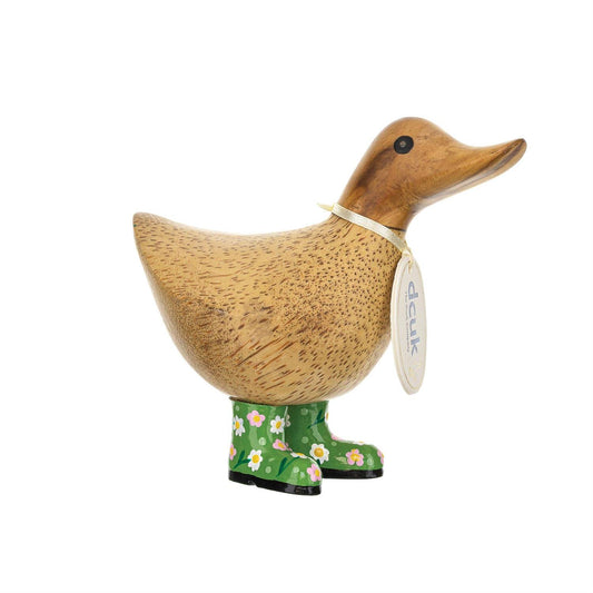 Wooden duck figurine wearing green boots with floral pattern on a white background