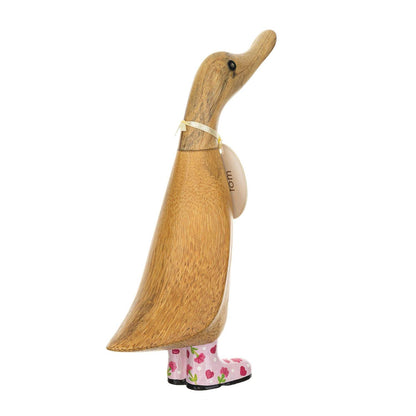 Wooden duck-shaped figurine with a floral-patterned boots on a white background