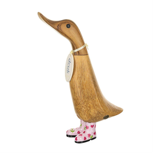 Wooden duck figurine with pink boots on a white background