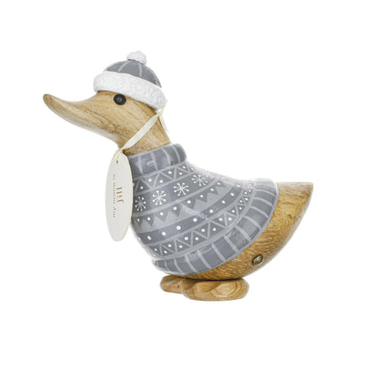Wooden duck figurine wearing a gray sweater and hat on a white background