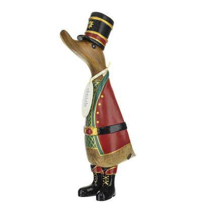 Wooden duck figurine dressed in a red and green Christmas costume on a white background