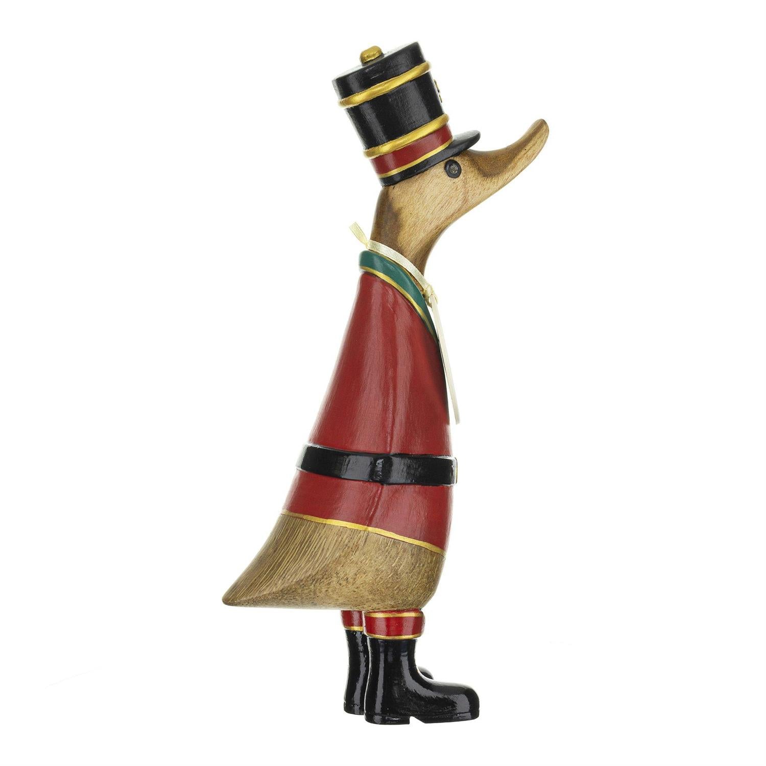 Wooden duck figurine dressed in a red and green Christmas costume on a white background