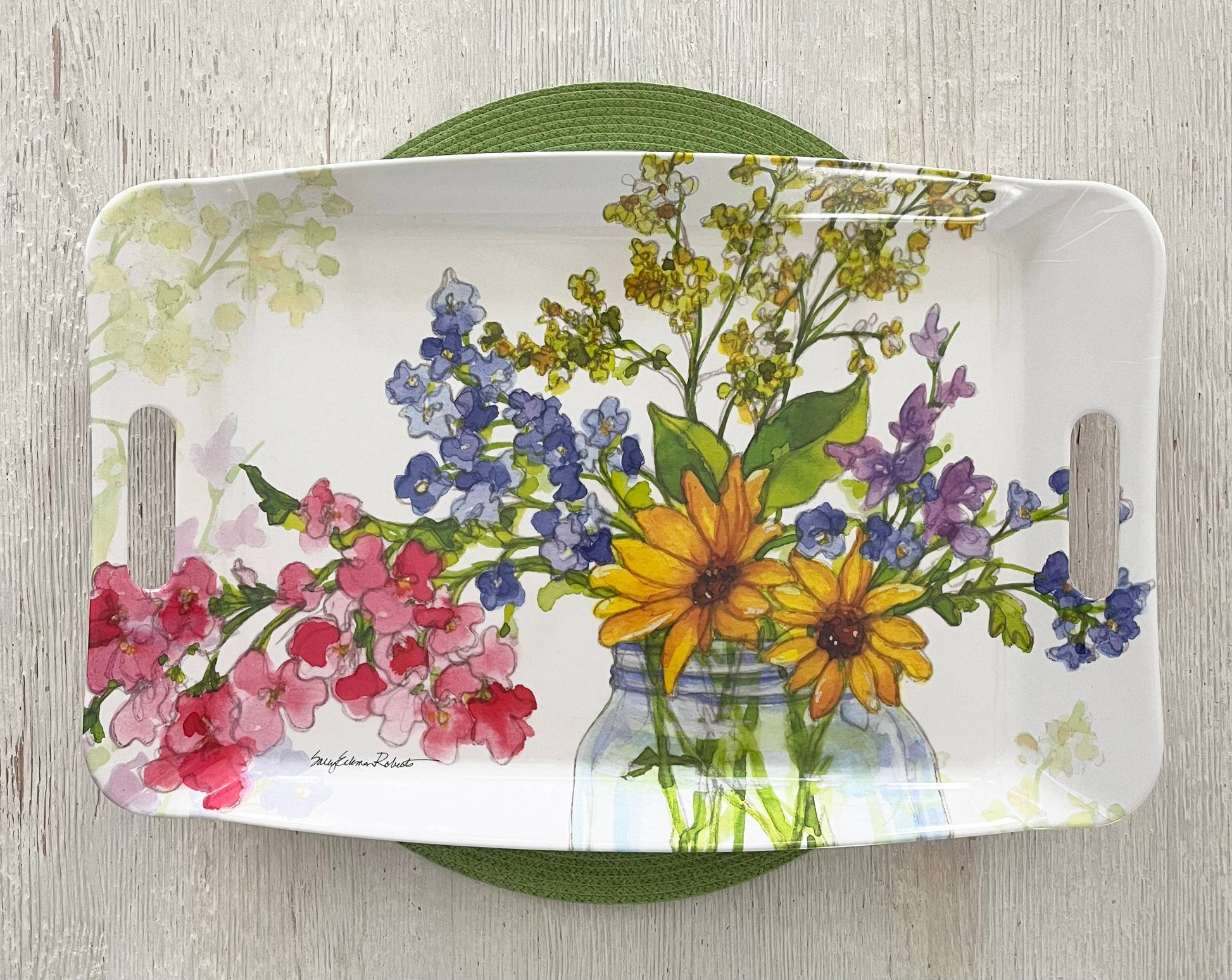 Decorative tray with floral design on a wooden surface