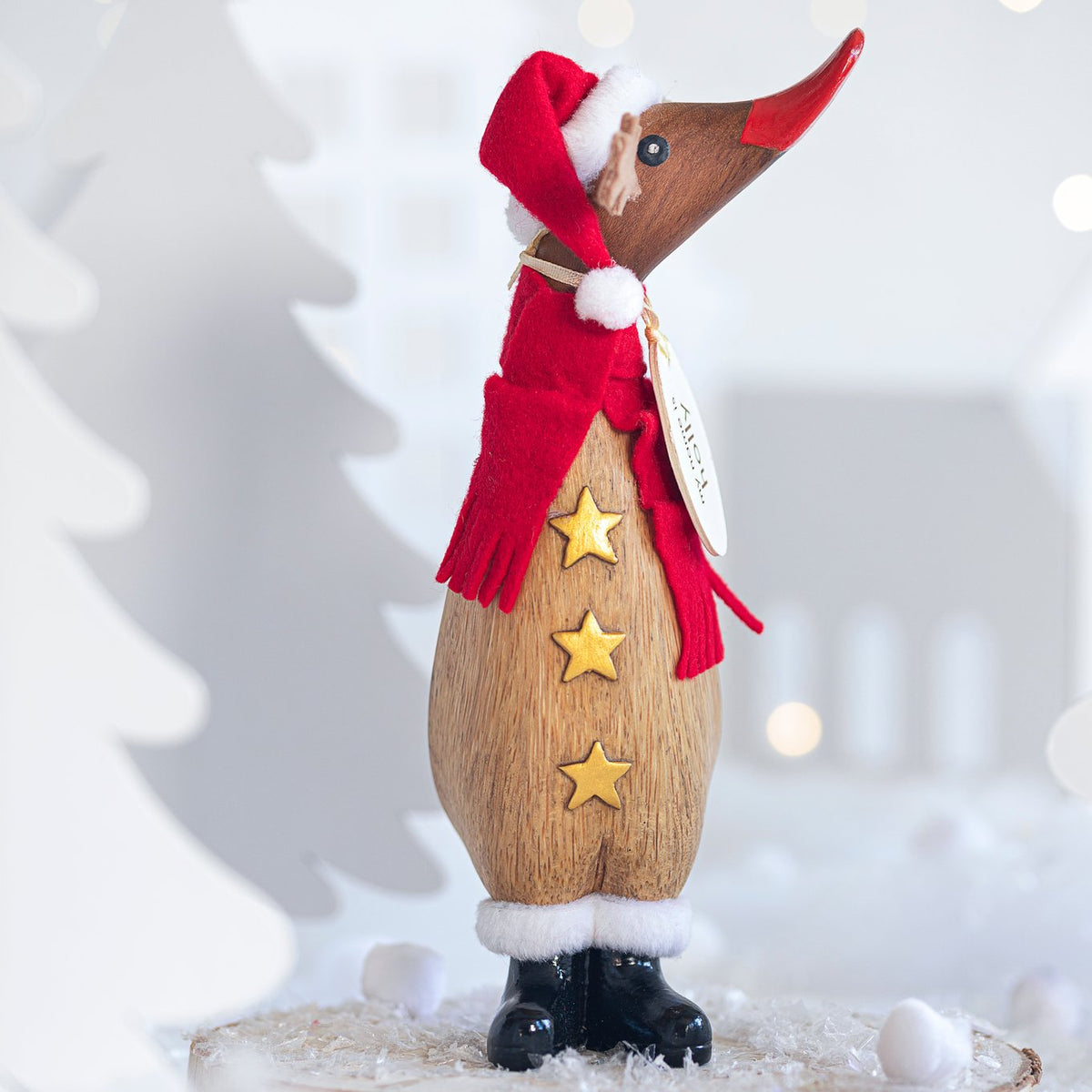 Wooden duck reindeer figurine with a red scarf and stars on a white background