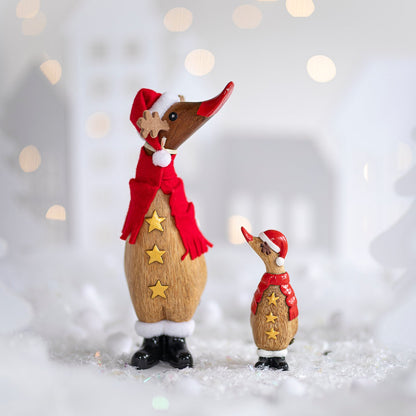 Two wooden duck reindeer figurines, one large, one small, on a white snowy background
