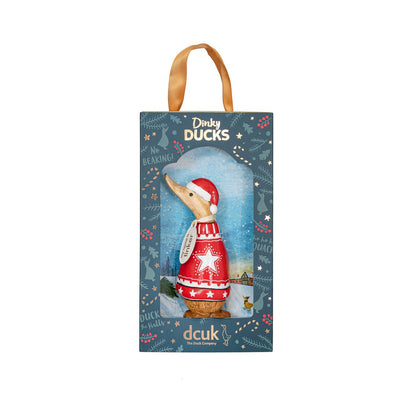 Packaged wooden duck wearing a red sweater with a star design on a blue background