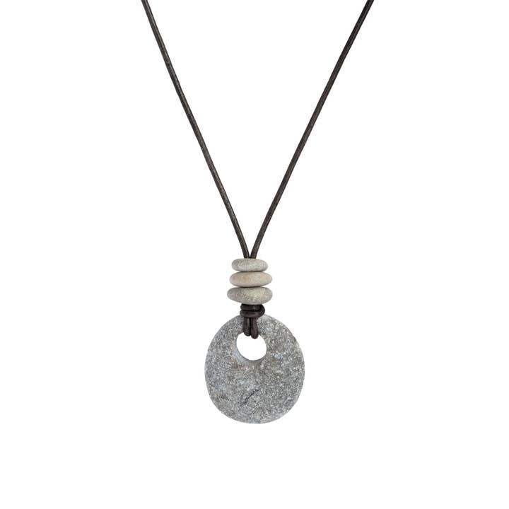 Necklace with a textured stone pendant and stone beads on a white background