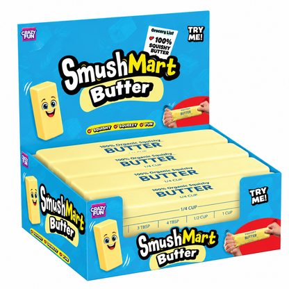 A bulk display box of SmushMart Butter by Crazy Fun, showing multiple yellow rectangular butter bars packaged in a bright blue box with cartoon-style branding and a 'TRY ME!' callout.