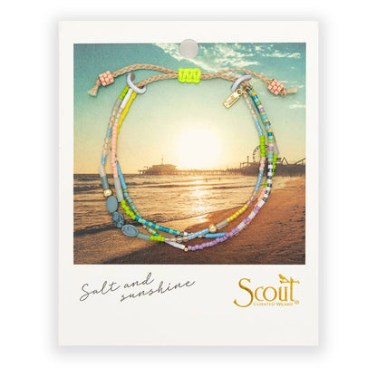 Colorful beaded bracelet on a card with a beach scene and 'Scout' branding