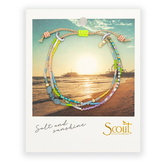 Colorful beaded bracelet on a card with a beach scene and 'Scout' branding
