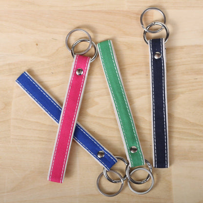 Four colorful keychains on a wooden surface