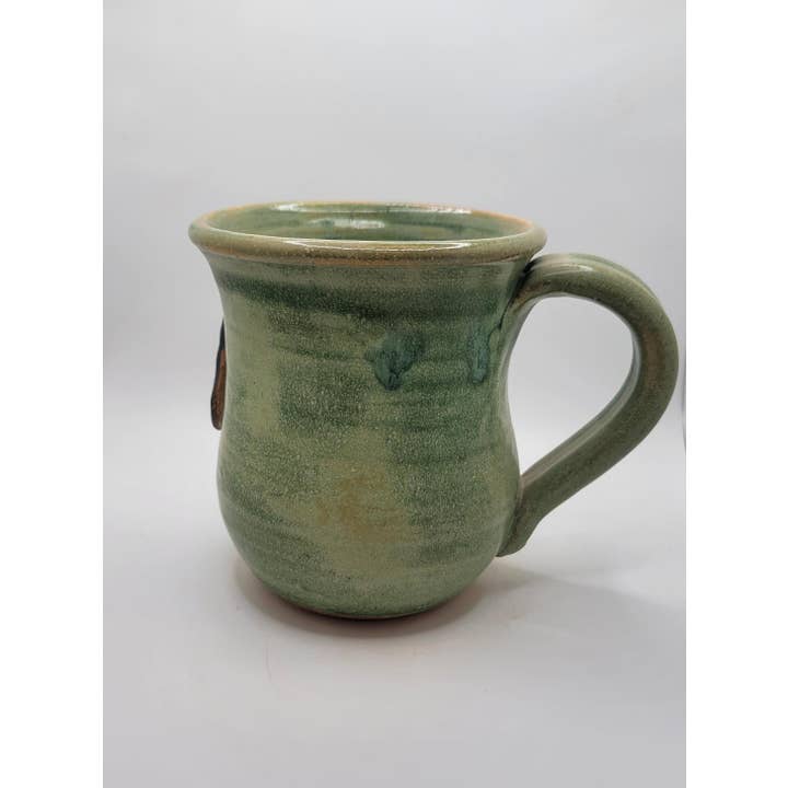 Green ceramic mug on a white background