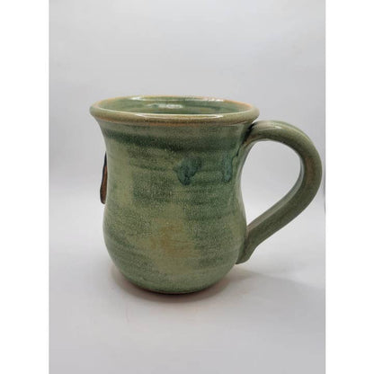 Green ceramic mug on a white background