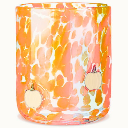 Decorative glass candle holder with orange and white abstract pattern on a white background.