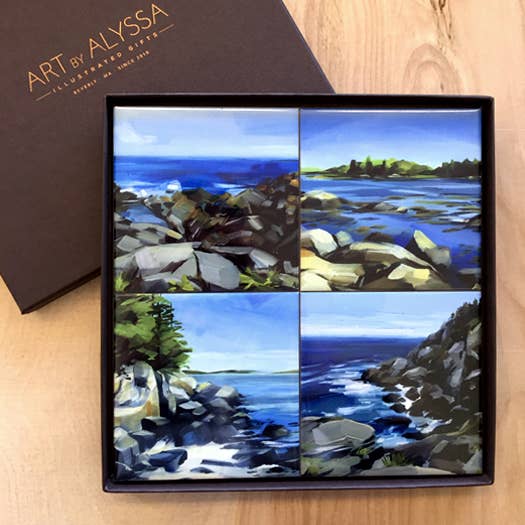 Set of four coastal landscape coasters in a gift box on a wooden surface with 'Art by Alyssa' branding.