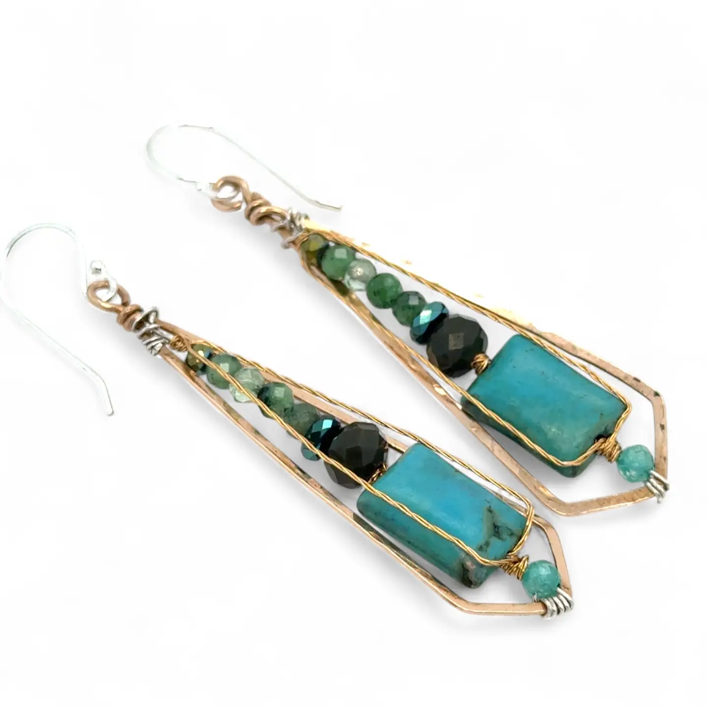 Pair of earrings with turquoise and green stones on a white background