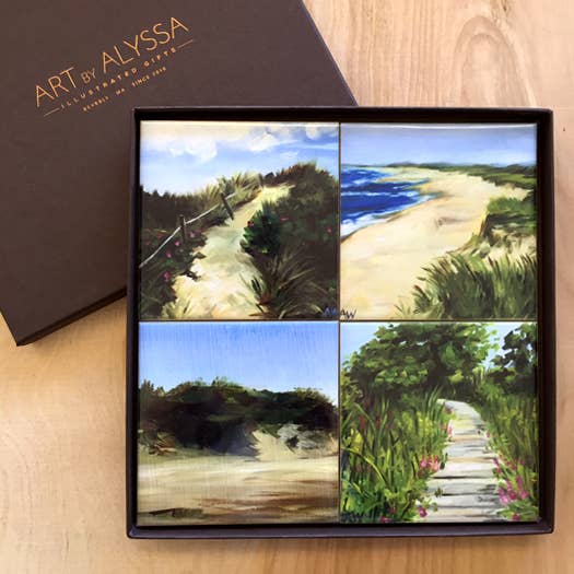Set of four scenic beach coasters in a gift box with 'Art by Alyssa' branding.