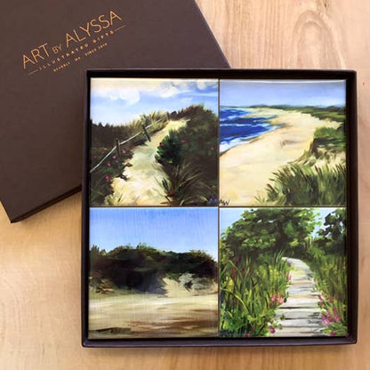 Set of four scenic beach coasters in a gift box with 'Art by Alyssa' branding.