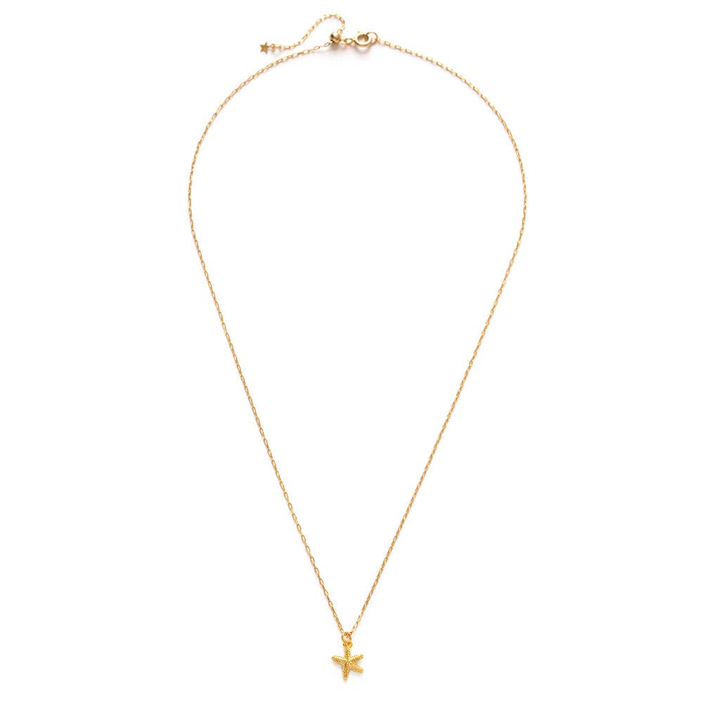 Gold necklace with a starfish pendant on a white background