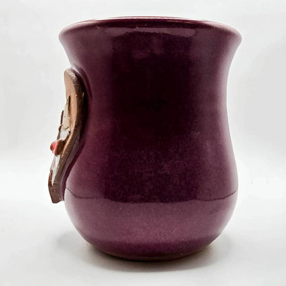 Purple ceramic mug with a decorative handle on a white background