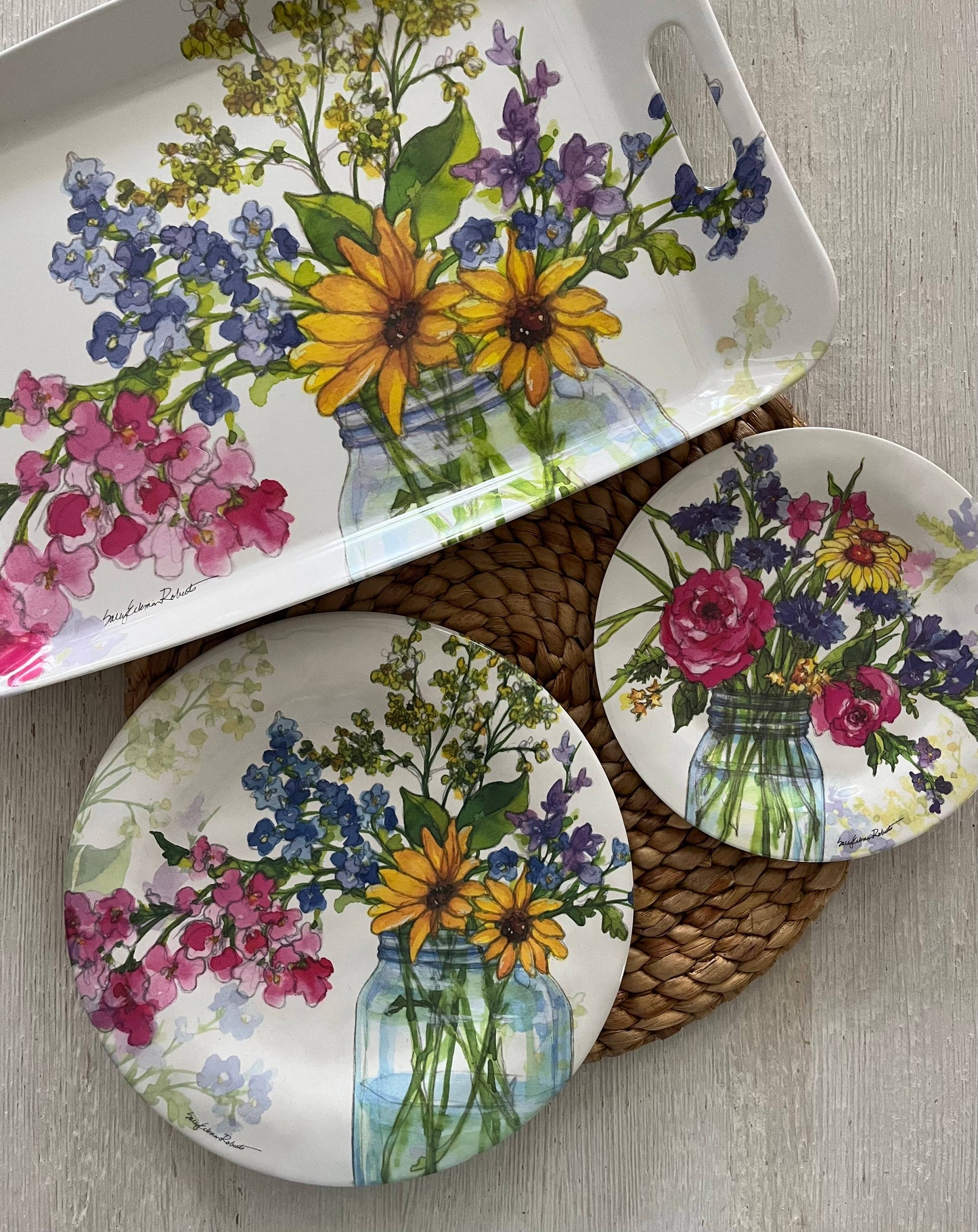 Dish set with floral design on a wooden surface